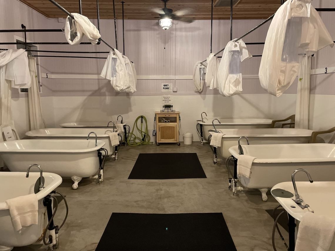 Row of clawfoot soaking tubs in the Carson Hot Springs bathhouse