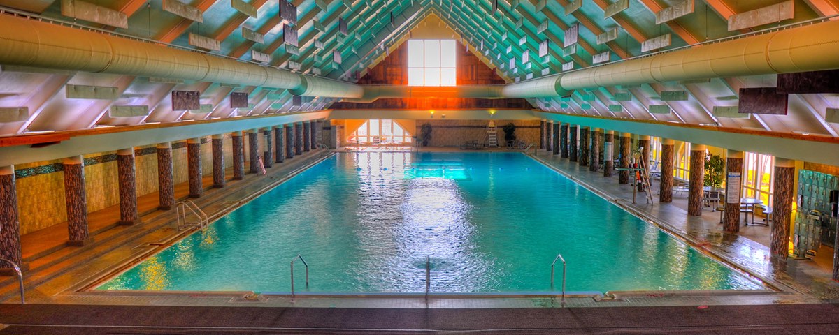 Fairmont Hot Springs' long indoor pool under a timbered vaulted roof