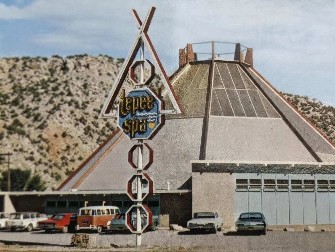Vintage photo of the tepee-shaped Tepee Spa building and its sign below a desert hillside